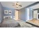 Staged spacious bedroom with a neutral color scheme, carpet and a ceiling fan at 1780 Oswego St, Aurora, CO 80010