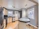 Well-lit kitchen with hardwood floors, stainless steel appliances, and washer/dryer in the background at 1780 Oswego St, Aurora, CO 80010