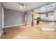 Open-concept living area with hardwood floors, gray walls, and seamless flow to the kitchen at 1780 Oswego St, Aurora, CO 80010