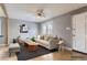 Virtually staged living room featuring modern furniture, gray walls, hardwood floors, and natural light at 1780 Oswego St, Aurora, CO 80010