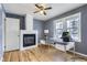 Cozy staged living room features a charming fireplace, a ceiling fan and lots of natural light from the windows at 1780 Oswego St, Aurora, CO 80010