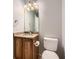 Bathroom featuring a wooden vanity, granite countertop, decorative lighting, and a modern toilet at 8750 Redwing Ave, Littleton, CO 80126