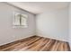 Bright bedroom featuring a window letting in natural light and wood-look floors at 8750 Redwing Ave, Littleton, CO 80126