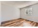Well-lit bedroom featuring a window letting in natural light and wood-look floors at 8750 Redwing Ave, Littleton, CO 80126
