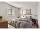 Cozy bedroom with a gray bedspread, gray rug, and wood floors at 8750 Redwing Ave, Littleton, CO 80126