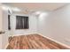 Bedroom featuring hardwood floors, a ceiling fan, and a sliding mirror closet at 8750 Redwing Ave, Littleton, CO 80126