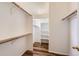 Walk-in closet with white shelving and warm-toned wood clothing racks at 8750 Redwing Ave, Littleton, CO 80126
