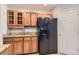 View of kitchen featuring wooden cabinetry, granite countertops, and a stainless steel refrigerator at 8750 Redwing Ave, Littleton, CO 80126