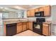Kitchen featuring granite countertops, a black oven and tile flooring at 8750 Redwing Ave, Littleton, CO 80126
