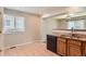 Open kitchen includes granite countertops, wooden cabinets, and a breakfast nook with natural light at 8750 Redwing Ave, Littleton, CO 80126