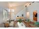 Cozy living room is complete with wood floors, an updated couch, and an airy feel at 8750 Redwing Ave, Littleton, CO 80126