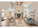 Bright living room features vaulted ceiling, built-in shelves, updated flooring, and a ceiling fan at 8750 Redwing Ave, Littleton, CO 80126