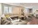 Spacious living room with an open concept design, hardwood floors, and two ceiling fans at 8750 Redwing Ave, Littleton, CO 80126