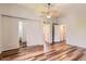 Bright and open main bedroom with hardwood floors and multiple interior doorways at 8750 Redwing Ave, Littleton, CO 80126