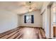 Comfortable bedroom featuring wood floors, a vaulted ceiling, and a large window with curtains at 8750 Redwing Ave, Littleton, CO 80126