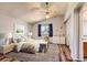 Bright main bedroom with a vaulted ceiling, hardwood floors, and an ensuite bathroom entrance at 8750 Redwing Ave, Littleton, CO 80126