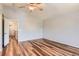 Open concept main bedroom featuring wood floors and an ensuite bathroom and closet at 8750 Redwing Ave, Littleton, CO 80126