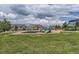 Community playground with play structures, swings, picnic area and shade trees at 8750 Redwing Ave, Littleton, CO 80126
