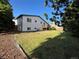 View of a well-maintained backyard with lush lawn and mature trees, offering a private outdoor space at 15908 E Flora Pl, Aurora, CO 80013
