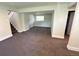 Finished basement area with plush carpeting, window and access to stairs at 15908 E Flora Pl, Aurora, CO 80013