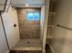 Beautiful bathroom with neutral colors, a new shower, and built-in shelving at 15908 E Flora Pl, Aurora, CO 80013