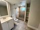 This bathroom has stone tile flooring, a walk-in shower, and a vanity at 15908 E Flora Pl, Aurora, CO 80013
