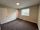 Bright bedroom with a window, neutral walls and carpet at 15908 E Flora Pl, Aurora, CO 80013