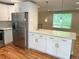 Beautiful kitchen with stainless steel refrigerator, white cabinets, and quartz countertops at 15908 E Flora Pl, Aurora, CO 80013