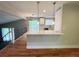 View of the open concept kitchen featuring a breakfast bar, modern lighting and stainless appliances at 15908 E Flora Pl, Aurora, CO 80013