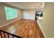 Bright living room with hardwood floors, large window, and an open layout to the kitchen at 15908 E Flora Pl, Aurora, CO 80013