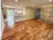 Spacious living room with hardwood floors leading into a modern kitchen and outdoor deck access at 15908 E Flora Pl, Aurora, CO 80013