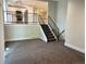View of living room and stairs to the kitchen with black railing at 15908 E Flora Pl, Aurora, CO 80013