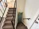 Carpeted staircase leading to basement, with handrail at 15908 E Flora Pl, Aurora, CO 80013