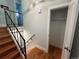 Bright stairway features hardwood steps and sleek black railing, with a glimpse of an upstairs bathroom at 15908 E Flora Pl, Aurora, CO 80013