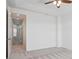 Bright bedroom with neutral carpet and an open doorway into an adjacent living space at 8962 E Otero Pl, Centennial, CO 80112