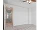Bedroom with neutral carpet and ceiling fan, door leading to hallway at 8962 E Otero Pl, Centennial, CO 80112