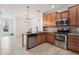 Well-equipped kitchen with stainless steel appliances, granite countertops, and wood cabinetry at 8962 E Otero Pl, Centennial, CO 80112