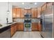 Stylish kitchen featuring stainless steel appliances, granite countertops, and ample wood cabinet storage at 8962 E Otero Pl, Centennial, CO 80112