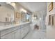 Bathroom with double vanity, soaking tub, marble floors, and a glass shower at 24316 E Ottawa Ave, Aurora, CO 80016