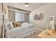 Bedroom with carpet, white furniture, blinds on the window, and a collage of photos on the wall at 24316 E Ottawa Ave, Aurora, CO 80016
