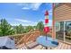 Outdoor deck area with a blue table and a red and white umbrella, perfect for outdoor relaxation at 24316 E Ottawa Ave, Aurora, CO 80016