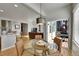 Charming dining nook with a round table, wicker chairs, and access to outdoor deck at 24316 E Ottawa Ave, Aurora, CO 80016