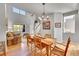 Inviting dining area with hardwood floors, decorative lighting, and open layout to the living room at 24316 E Ottawa Ave, Aurora, CO 80016