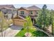 Beautiful two-story home with a two-car garage, manicured lawn, and stone accents on the facade at 24316 E Ottawa Ave, Aurora, CO 80016