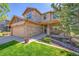 Charming two-story home showcasing stone accents, covered porch, and manicured landscaping at 24316 E Ottawa Ave, Aurora, CO 80016