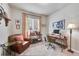 Cozy home office with comfortable seating, desk, and natural light from the window at 24316 E Ottawa Ave, Aurora, CO 80016