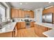 Bright kitchen features wood floors, stainless steel appliances, and light wood cabinetry at 24316 E Ottawa Ave, Aurora, CO 80016