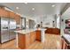 Open-concept kitchen with stainless steel appliances that flows into the living room with hardwood floors at 24316 E Ottawa Ave, Aurora, CO 80016
