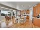 Open kitchen and dining area with hardwood floors, an island, and stainless steel appliances at 24316 E Ottawa Ave, Aurora, CO 80016