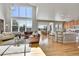 Bright living room with high ceilings, large windows, hardwood floors, and open floor plan at 24316 E Ottawa Ave, Aurora, CO 80016